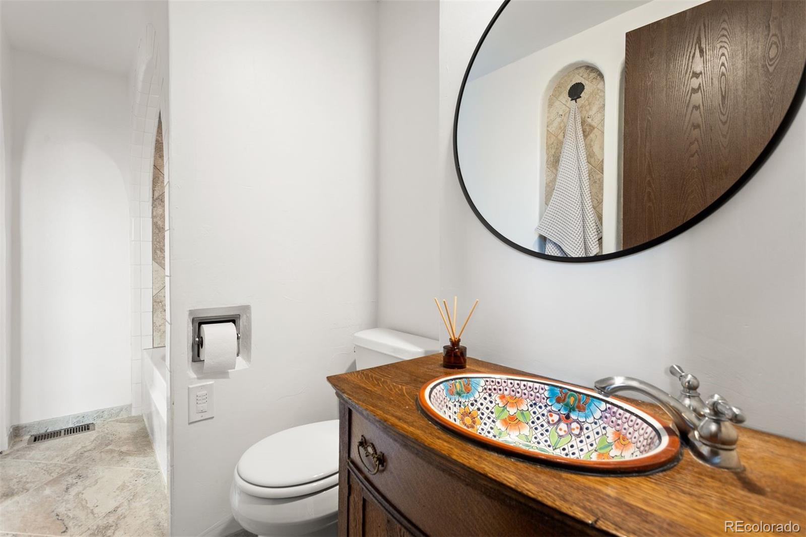 616 South Pine Drive Bailey, CO 80421 - Photo 32 of 50 a bathroom with a toilet a sink and mirror