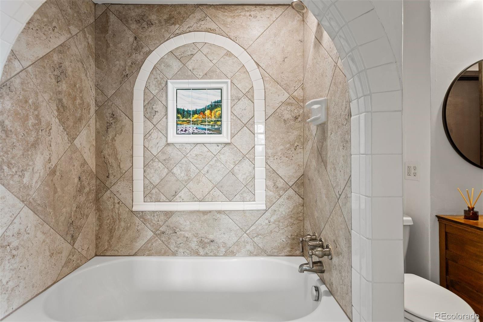 616 South Pine Drive Bailey, CO 80421 - Photo 34 of 50 a bathroom with a bathtub and shower