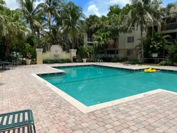 a view of a house with swimming pool and a garden