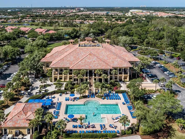 an outdoor space with lots of green space and mountain view in back