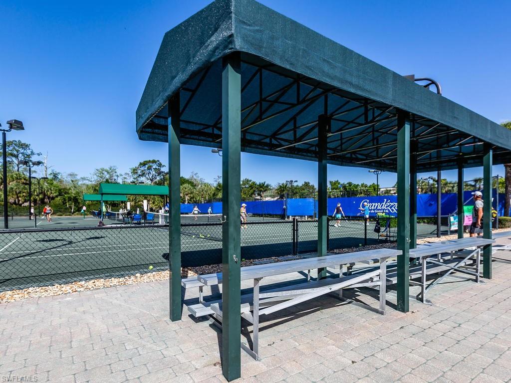20174 Markward Crossing Estero, FL 33928 - Photo 26 of 30 a view of a chairs and table in the patio and a fountain