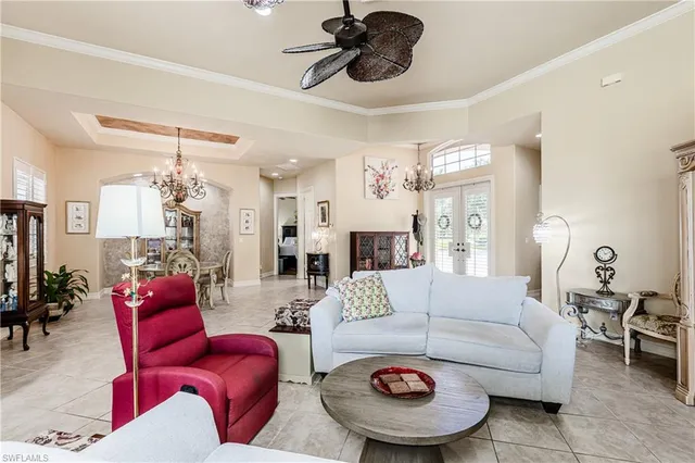 a living room with furniture and a chandelier