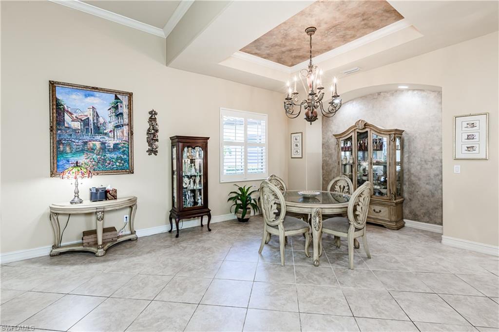 20174 Markward Crossing Estero, FL 33928 - Photo 6 of 30 a dining room with furniture a chandelier and a painting