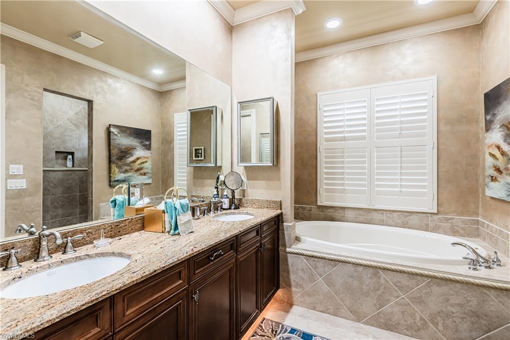 20174 Markward Crossing Estero, FL 33928 - Photo 9 of 30 a bathroom with a granite countertop tub sink and mirror