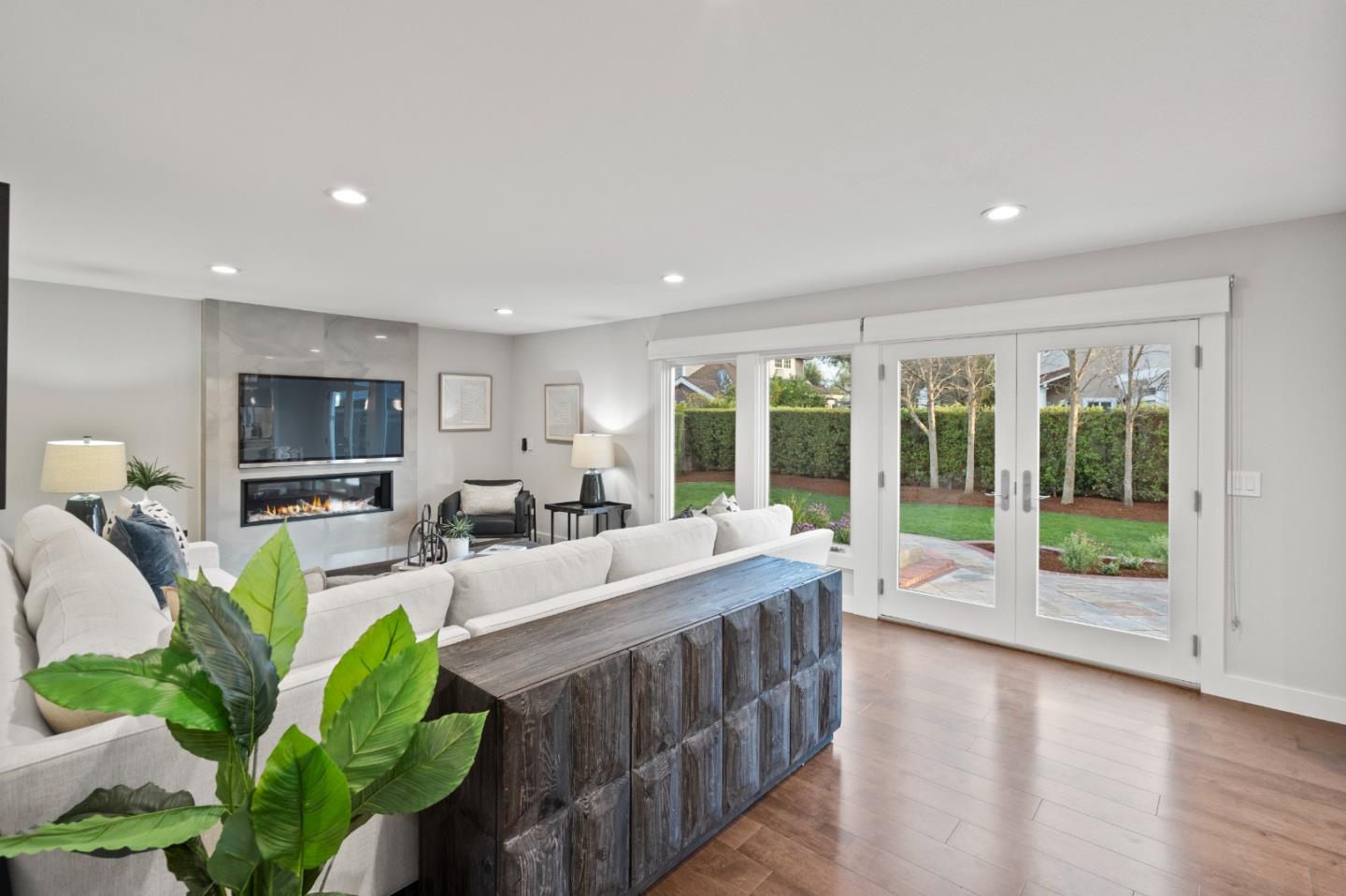 389 Bryant Avenue Mountain View, CA 94040 - Photo 15 of 61 a living room with furniture a flat screen tv and a potted plant