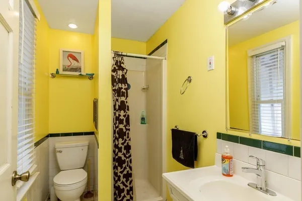 a bathroom with a sink toilet and shower