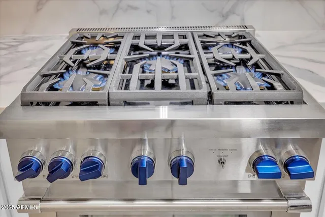 a kitchen with stainless steel appliances granite countertop a stove and cabinets