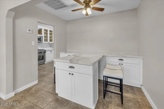 a kitchen with granite countertop a sink and a stove