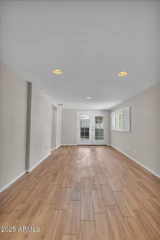 a view of empty room with wooden floor