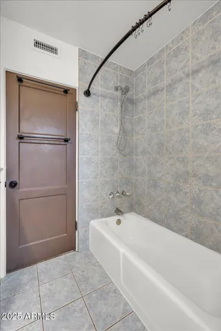 an empty room with closet and windows