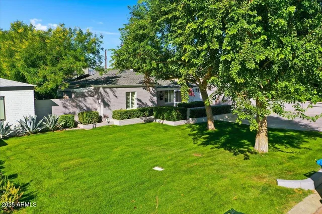 a view of house with backyard