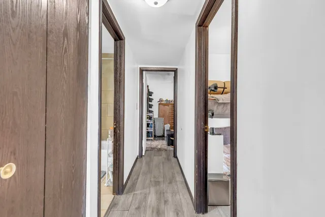 a view of a hallway with wooden floor and staircase