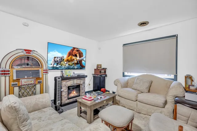 a living room with furniture a rug and a fireplace
