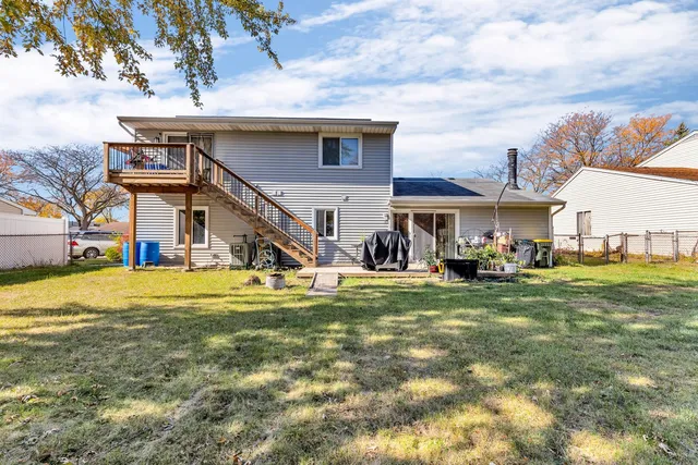 a view of a house with a big yard and sitting area