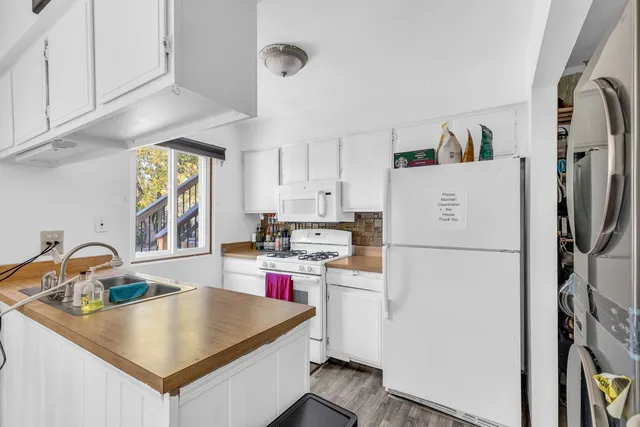 a kitchen with a refrigerator a sink and a stove
