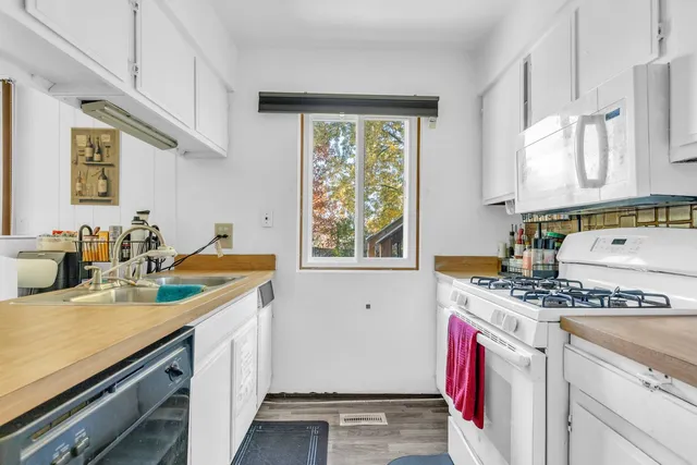 a kitchen with a sink stove and cabinets