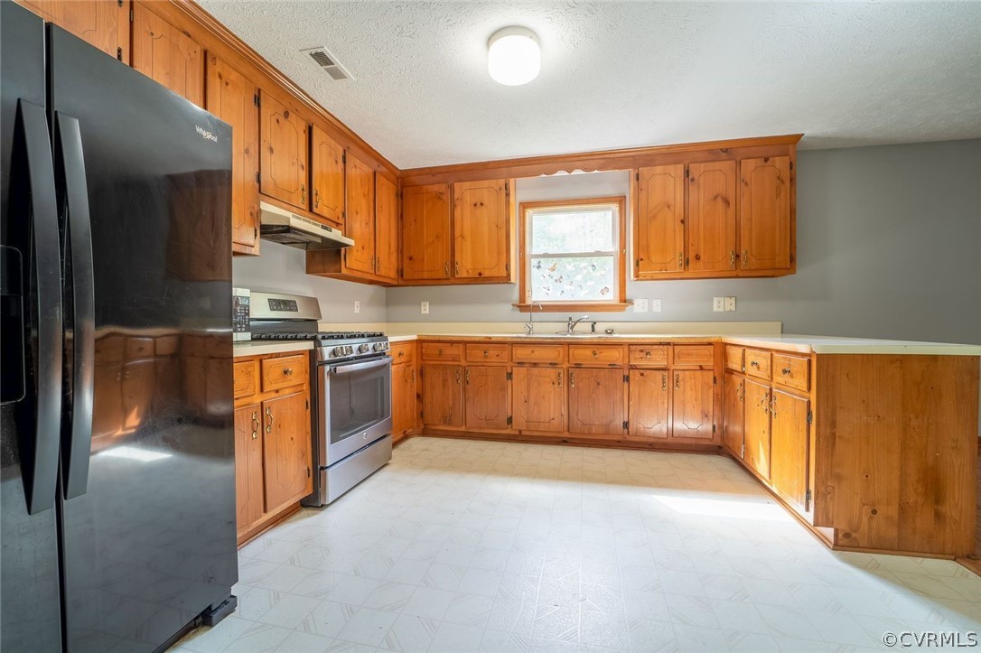 2263 Pony Farm Road Maidens, VA 23102 - Photo 11 of 27 a kitchen with stainless steel appliances granite countertop a stove a sink and a refrigerator