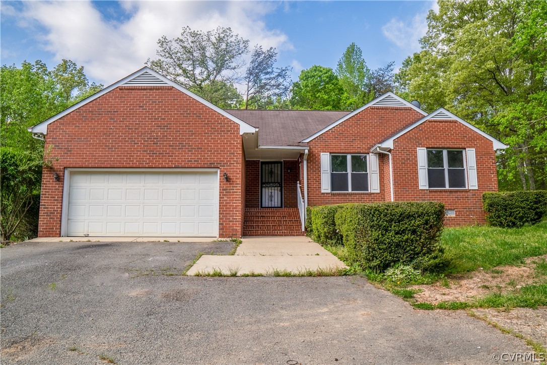 2263 Pony Farm Road Maidens, VA 23102 - Photo 2 of 27 a front view of a house with a garden and garage