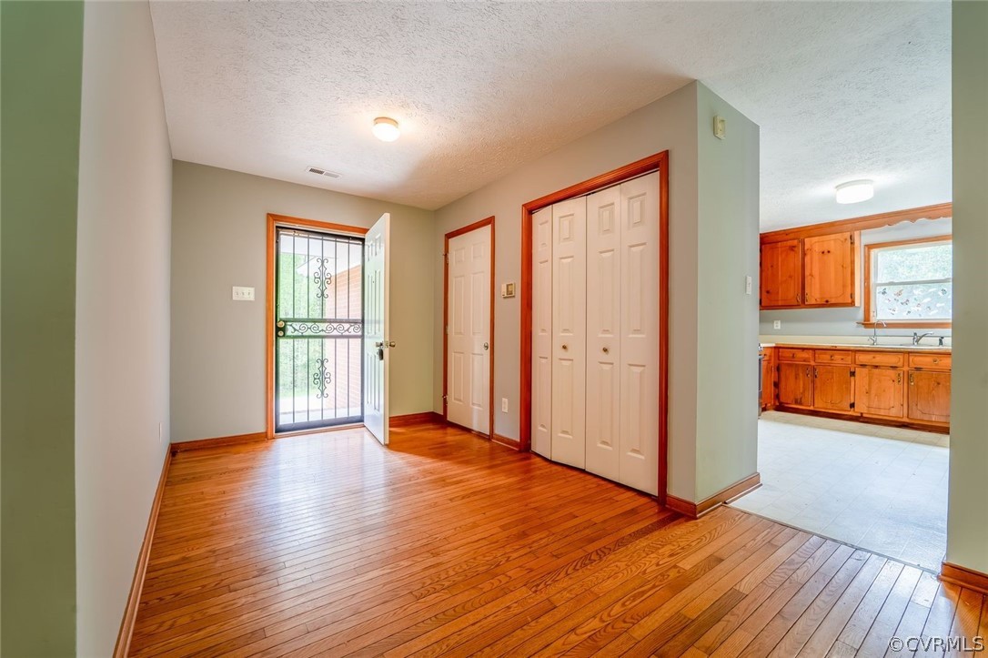 2263 Pony Farm Road Maidens, VA 23102 - Photo 6 of 27 an empty room with wooden floor and windows