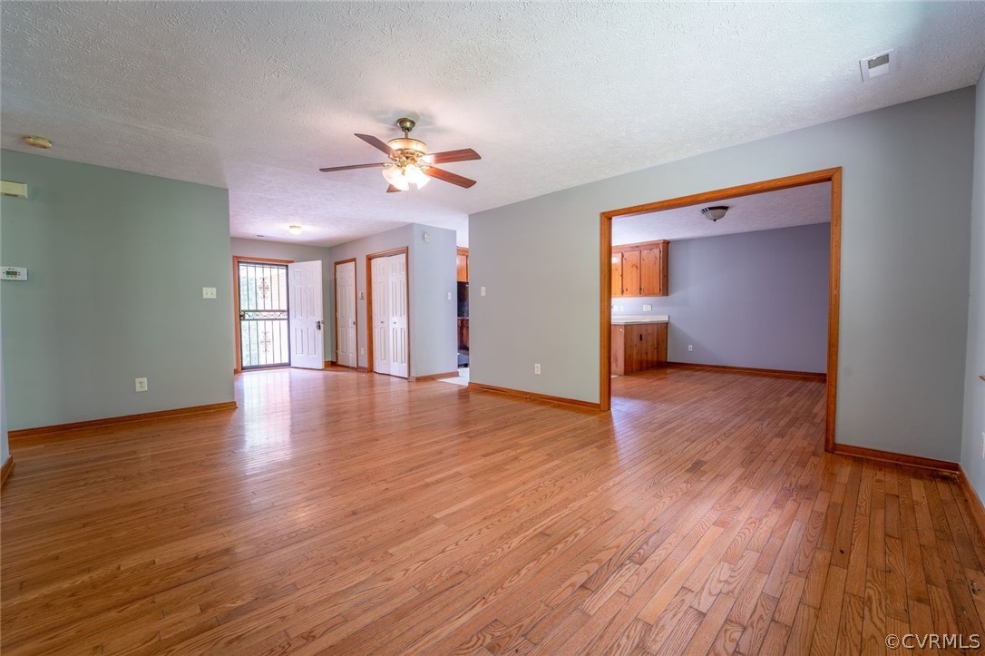 2263 Pony Farm Road Maidens, VA 23102 - Photo 9 of 27 a view of an empty room with a window and wooden floor