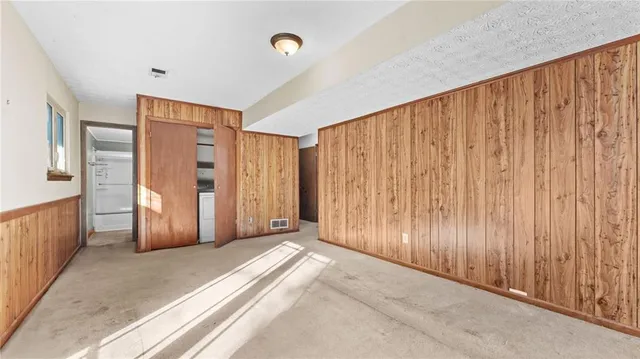 a view of a livingroom with staircase and door