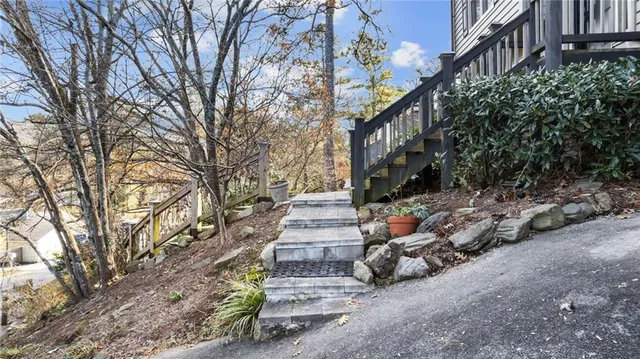 a view of a yard with plants and trees
