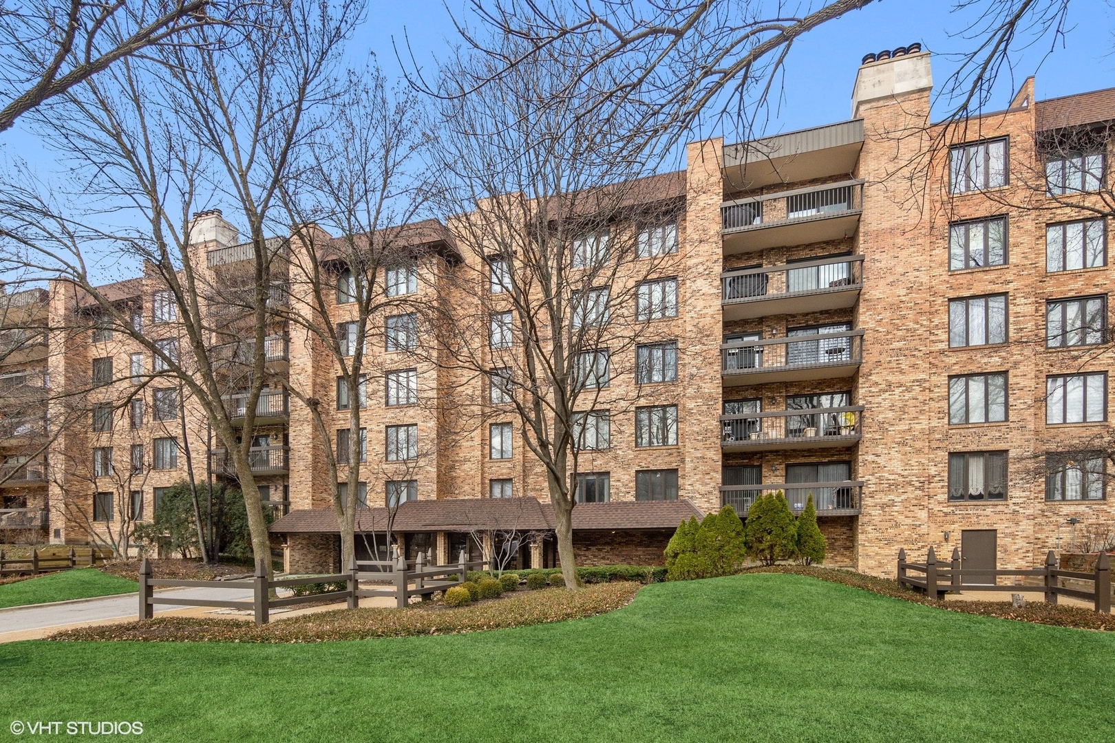 1800 Mission Hills Road, Unit 212 Northbrook, IL 60062 - Photo 1 of 19 front view of a building with a yard