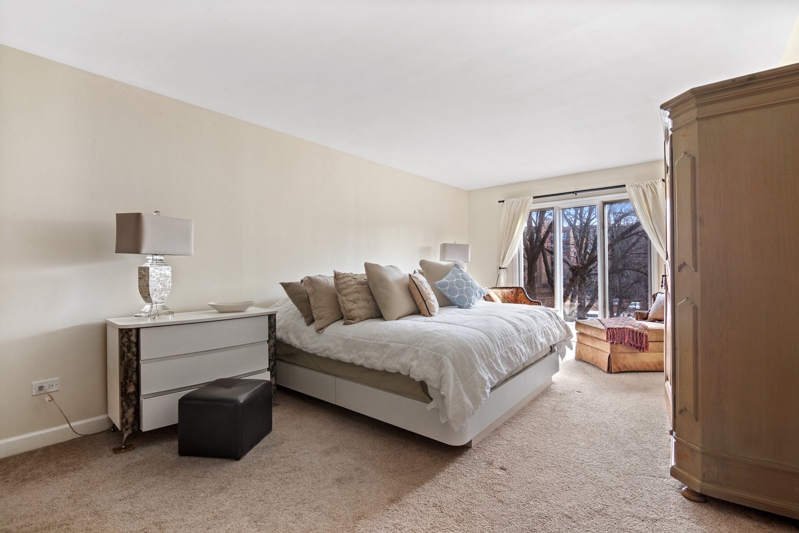 1800 Mission Hills Road, Unit 212 Northbrook, IL 60062 - Photo 12 of 19 a spacious bedroom with a bed and a dresser