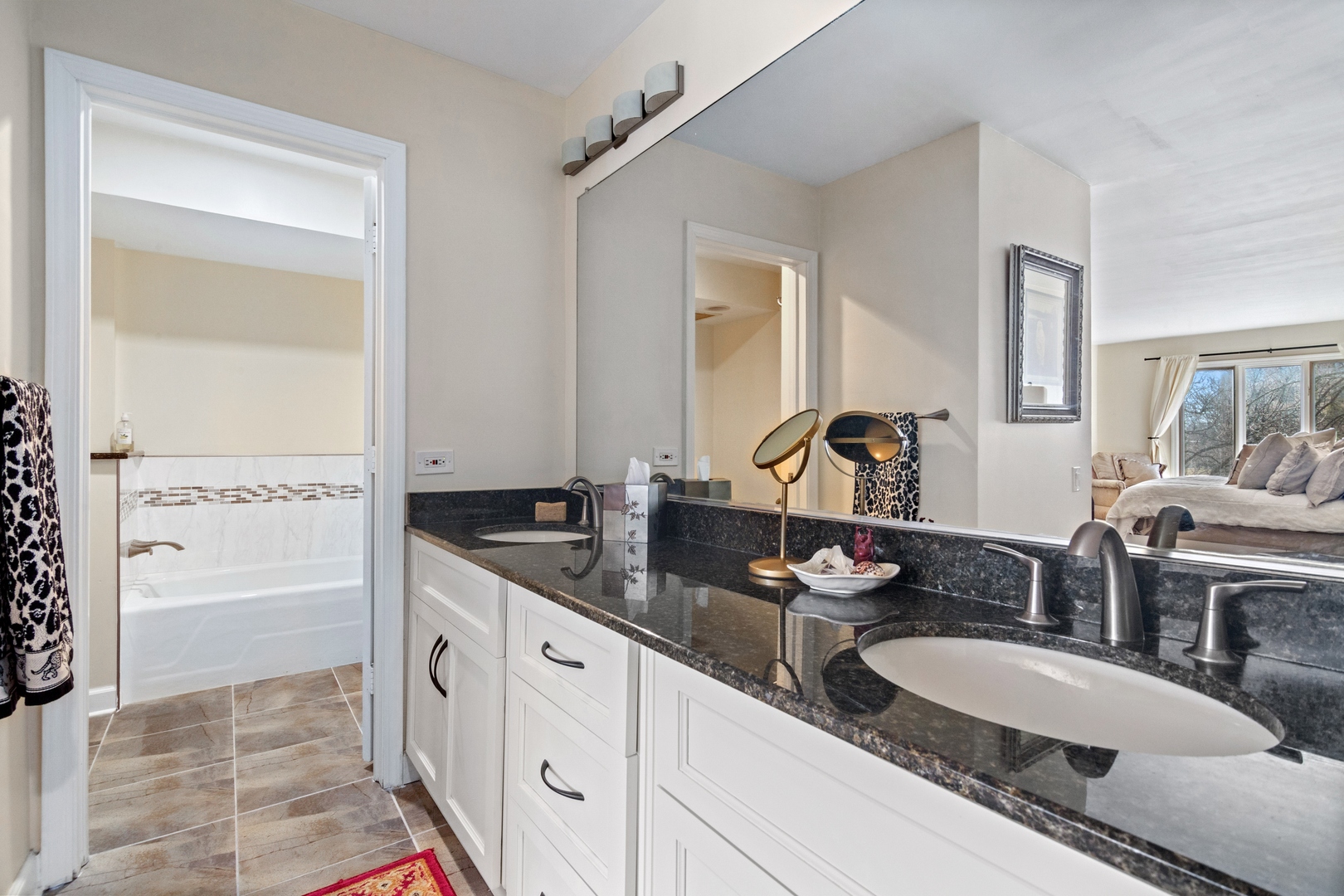 1800 Mission Hills Road, Unit 212 Northbrook, IL 60062 - Photo 13 of 19 a bathroom with double vanity sinks a mirror and a shower
