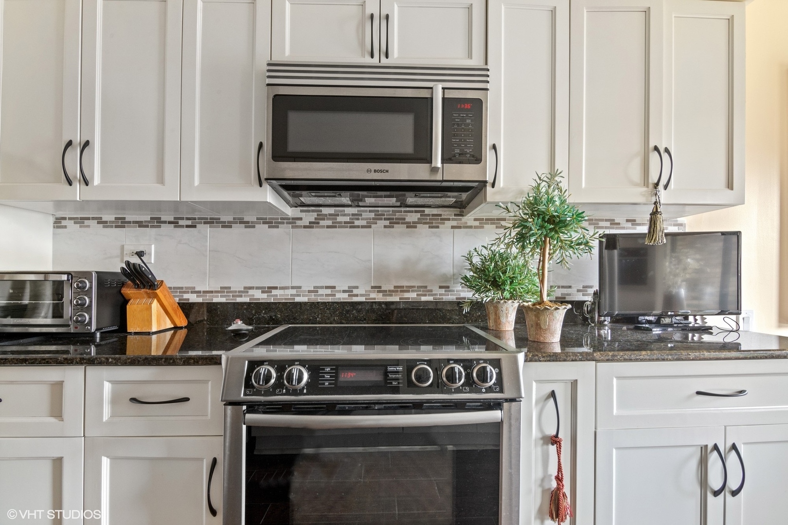1800 Mission Hills Road, Unit 212 Northbrook, IL 60062 - Photo 8 of 19 a kitchen with granite countertop a stove and a sink