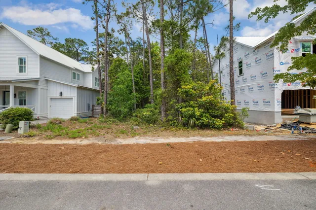 a view of a house with a yard and pathway