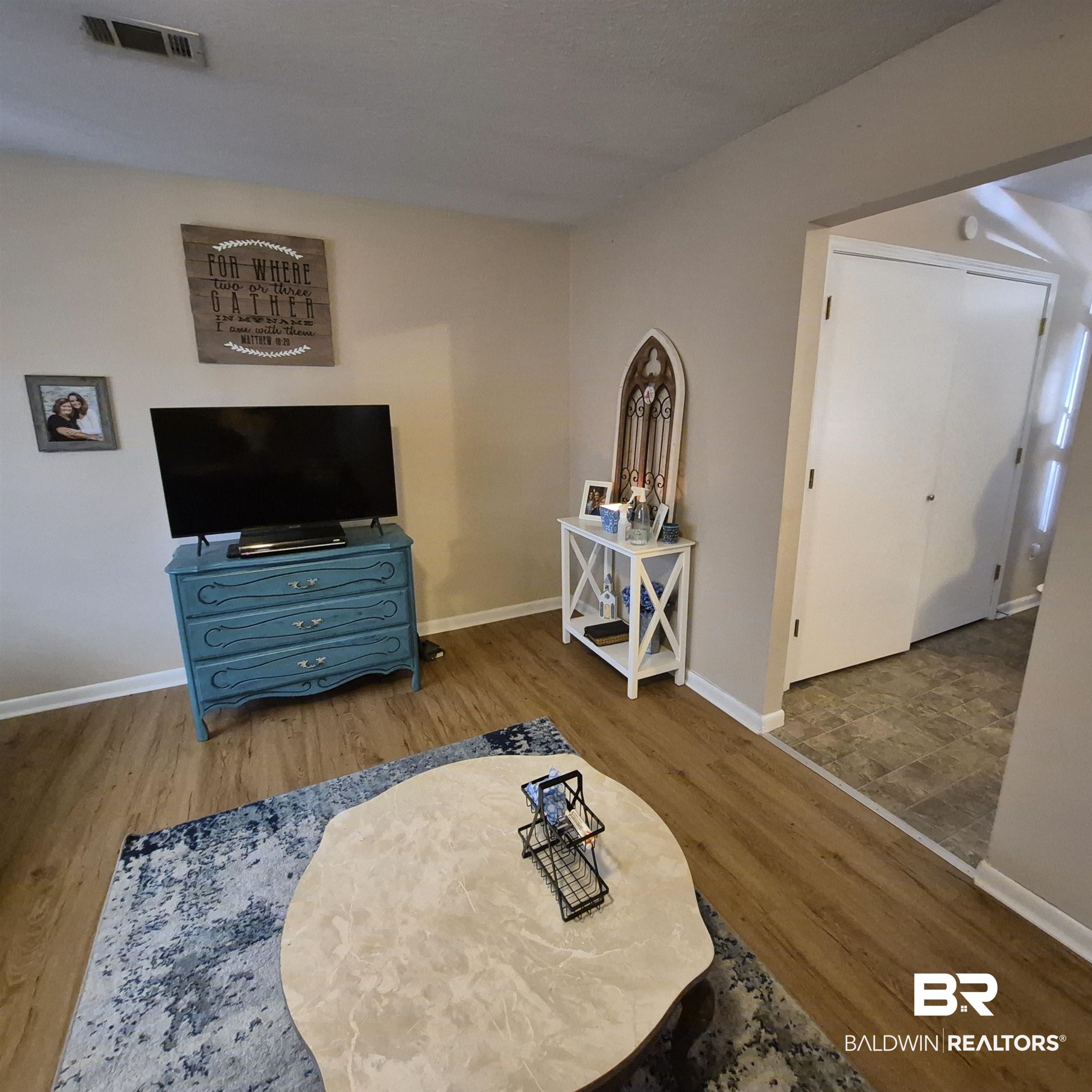 721 Perryman Street Evergreen, AL 36401 - Photo 8 of 26 Living area featuring baseboards and wood finished floors