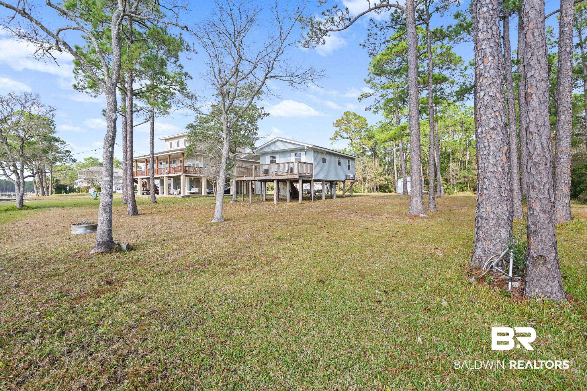 7947 Bayshore Drive Elberta, AL 36530 - Photo 3 of 26 View of grassy yard featuring a wooden deck