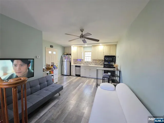 a living room with furniture and kitchen view