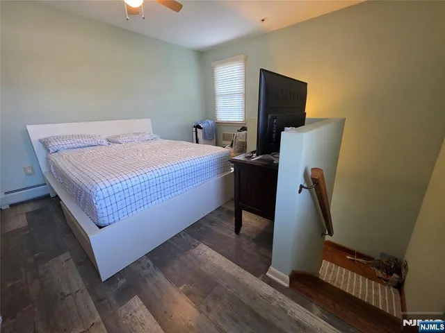 a bedroom with a bed and flat screen tv