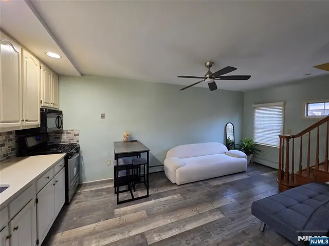 a spacious bedroom with a bed and a chandelier