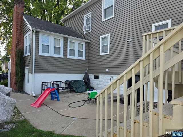 a view of a house with backyard and porch