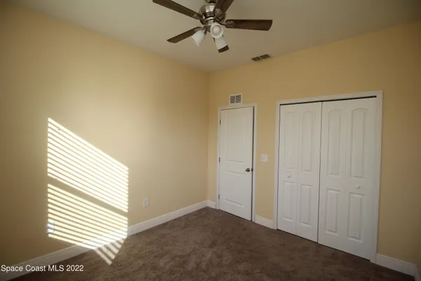 a view of an empty room and a window