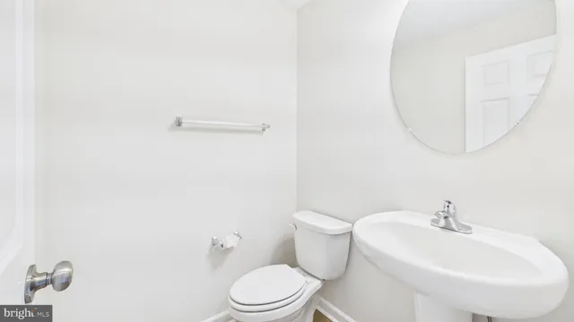 a white toilet sitting next to a bathroom sink