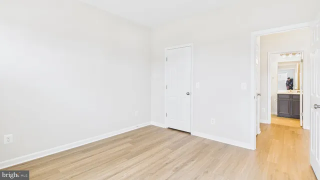 a view of a room with wooden floor