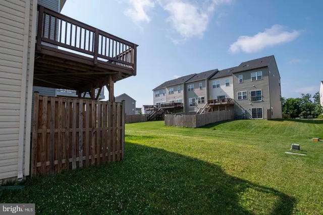a view of a house with backyard and porch