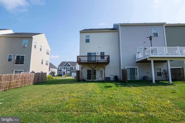 a view of a house with pool and a yard