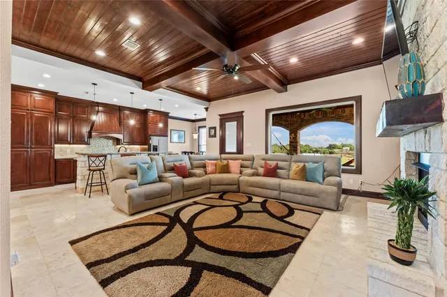 a living room with lots of furniture and kitchen view