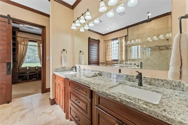 a bathroom with a granite countertop sink a large mirror and a shower