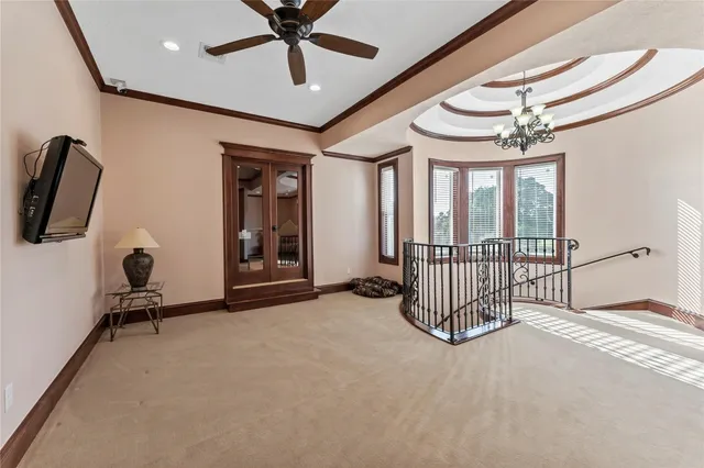 a view of a livingroom with furniture and a ceiling fan