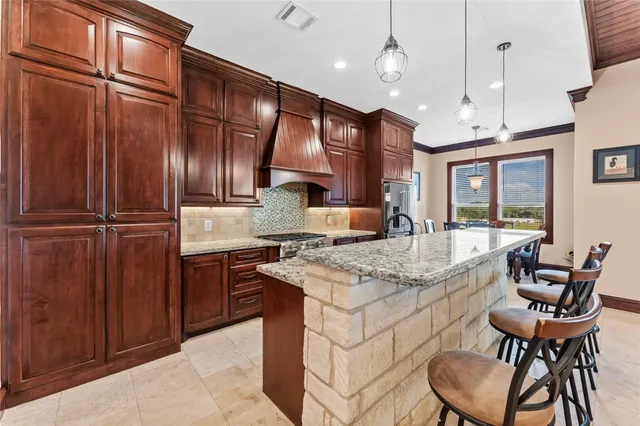 a kitchen with cabinets and chairs
