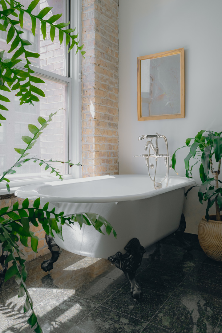 727 South Dearborn Street, Unit 910 Chicago, IL 60605 - Photo 14 of 37 a white bath tub sitting in a bathroom
