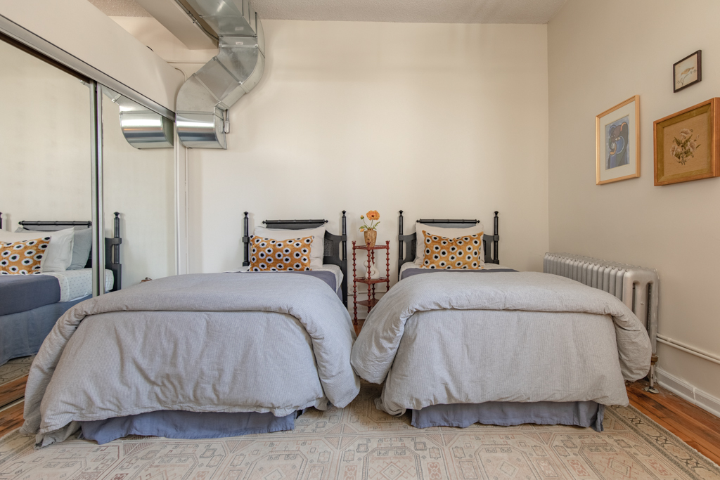 727 South Dearborn Street, Unit 910 Chicago, IL 60605 - Photo 28 of 37 a bedroom with two beds and painted walls