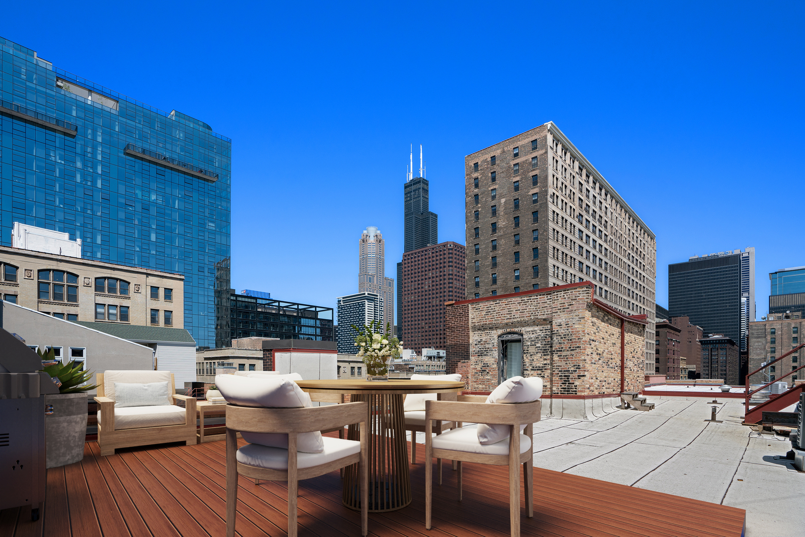 727 South Dearborn Street, Unit 910 Chicago, IL 60605 - Photo 31 of 37 a view of a patio with couches table and chairs under an umbrella with wooden floor