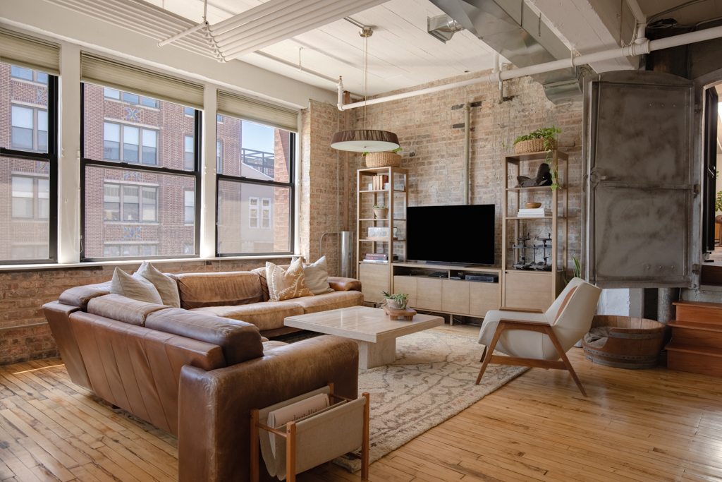 727 South Dearborn Street, Unit 910 Chicago, IL 60605 - Photo 6 of 37 a living room with furniture wooden floor and a flat screen tv